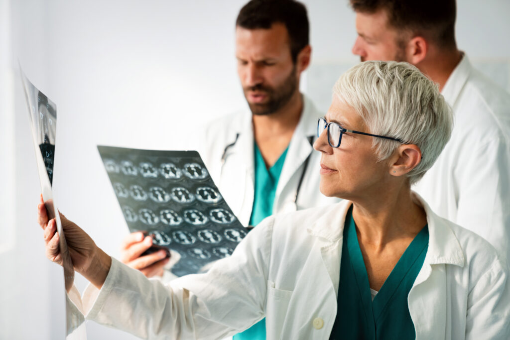 Group of radiology doctor looking at x-ray and discussing it